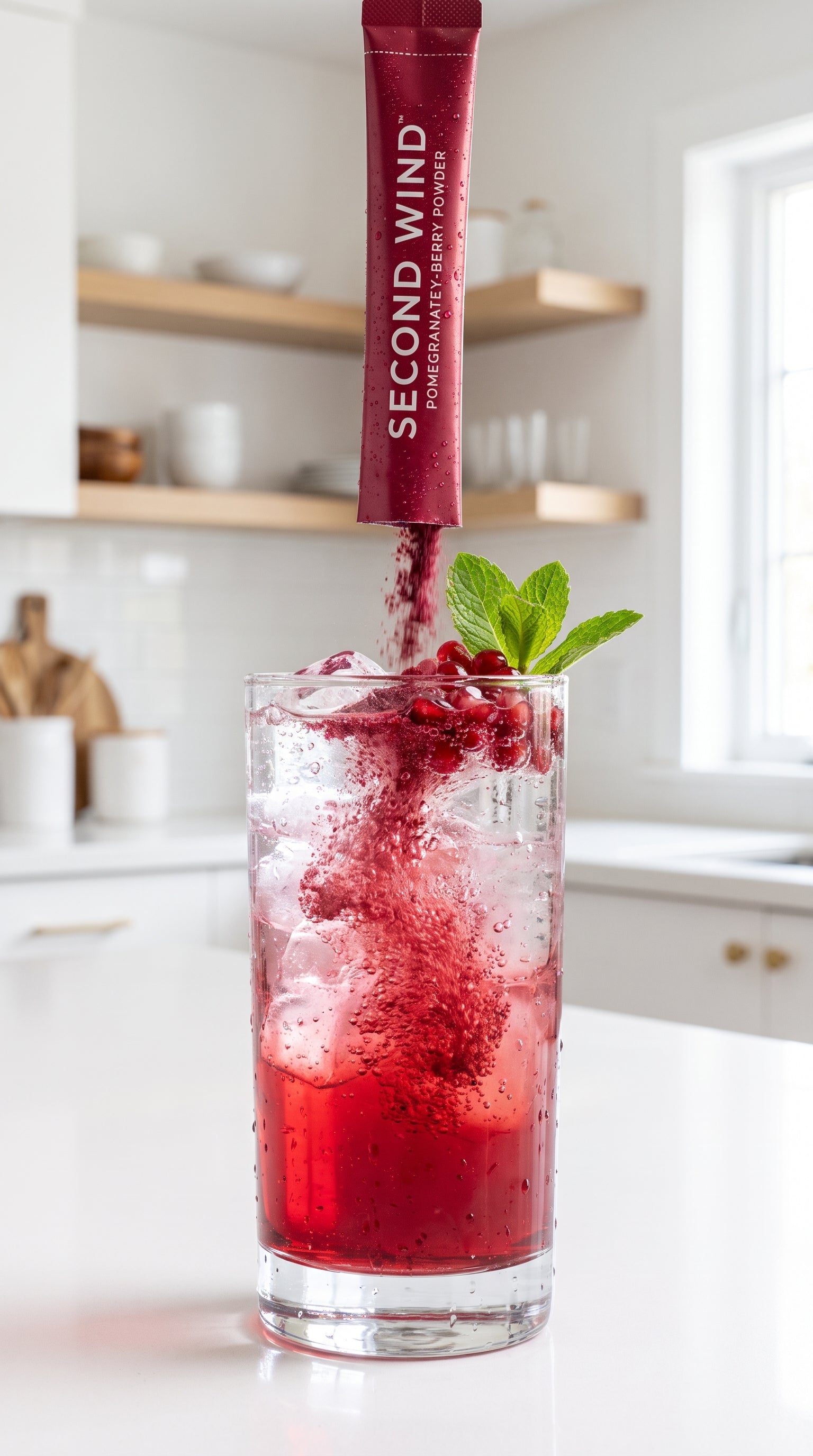 Pouring Second Wind pomegranate berry powder into sparkling water
